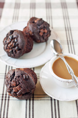 Homemade chocolate muffins/buns with cup of coffee. Still life