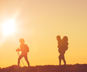 Hikers with Backpacks at Sunset