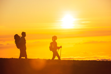 Fototapeta na wymiar Hikers with Backpacks at Sunset