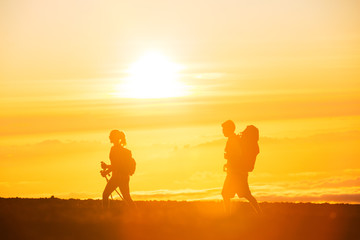 Fototapeta na wymiar Hikers with Backpacks at Sunset