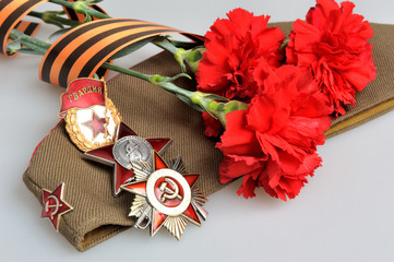 Military cap, red flowers, Saint George ribbon, orders of Great