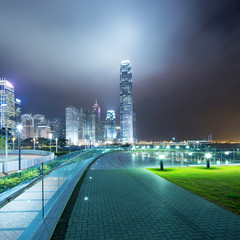 Naklejka premium pathway in the night with modern city background