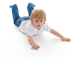 Portrait of a cute little boy lying on floor