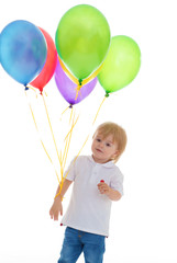 Fototapeta na wymiar child boy with bunch of colourful balloons