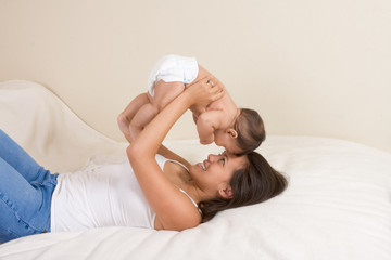 Mother playing with her baby boy son