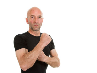 Man in black teeshirt with one arm raised