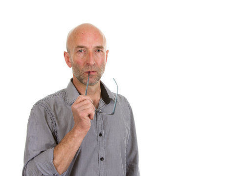 Man stood thinking with spectacles on a white background