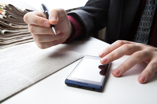 man working on a smartphone in office