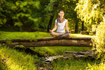 Young female meditate in nature