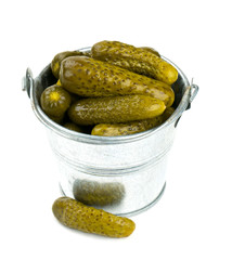 pickled cucumbers in a metal bucket isolated on white