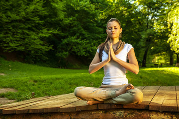 Young female meditate in nature - obrazy, fototapety, plakaty