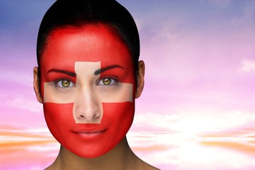 Composite image of beautiful brunette in swiss facepaint