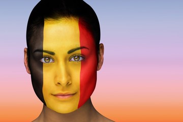Composite image of beautiful brunette in belgium facepaint