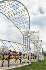Fototapeta premium White metal park pergola with benches