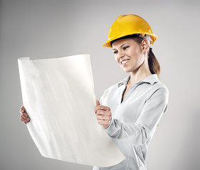 Smiling female architect holding blueprints and black folder