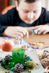 Christmas decoration and boy cutting gingerbread dough