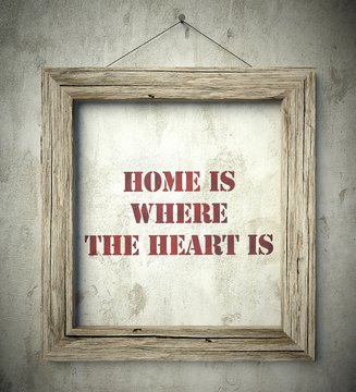 Home is where the heart is in old wooden frame