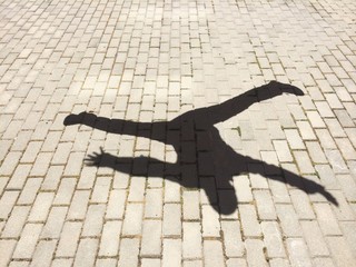 The shadow of a happy man jumping