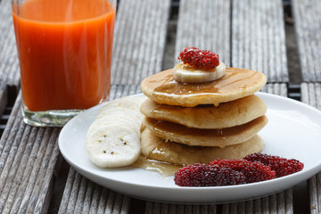 Stack of delicious pancakes with fresh fruits