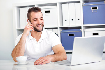 Happy business man talking on the phone