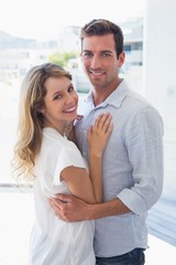 Loving young man embracing woman