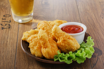 breaded chicken wings with ketchup and beer