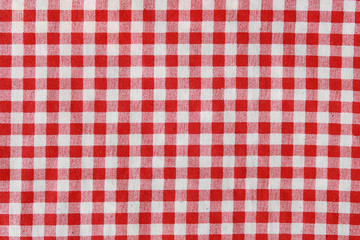 Texture of a red and white checkered picnic blanket.