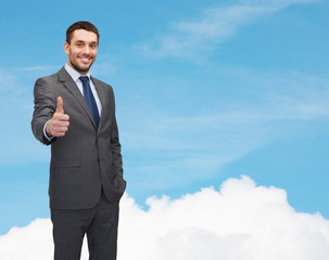 handsome businessman showing thumbs up