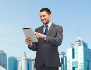 smiling businessman with tablet pc computer