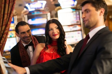 Young people near slot machine in a casino