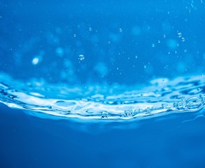 Blue water background with splashes and bubbles