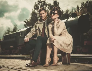 Deurstickers Vintage couple on train station platform © Nejron Photo