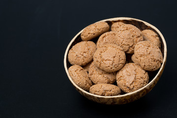biscotti cookies in a bowl on a black background