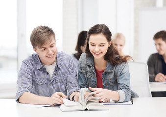 Fototapeta premium two teenagers with notebooks and book at school