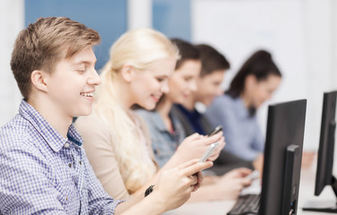 Fototapeta premium students with computer monitor and smartphones
