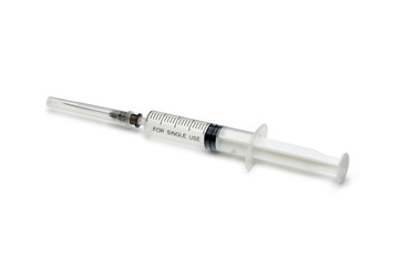 Plastic disposable syringe with a needle in the protective cap