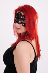 Young plump red-haired woman with mask