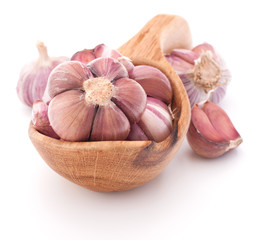 Garlic cloves in wooden bowl isolated on white background