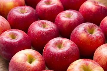 Many red apples on a wooden background. Nature fruit concep