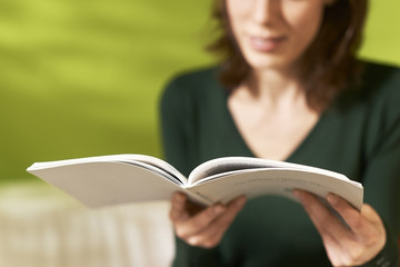 girl studying literature with book at home