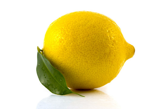 lemon with green leaf isolated on white background