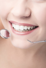 Smiling Healthy Woman Mouth Closeup With Dentist Mirror and Spat