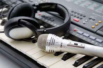 microphone and ear-phones lie on the keyboard