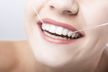 Caucasian Woman Mouth Closeup with Dental Floss.