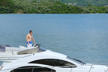 Fototapeta na wymiar young man on yacht
