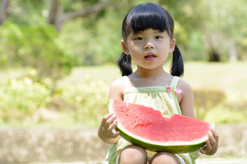 Little child eating watermelon