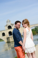 Fototapeta na wymiar cheerful young couple on holiday sightseeing and visiting