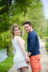 Fototapeta premium cheerful young couple on holiday sightseeing and visiting