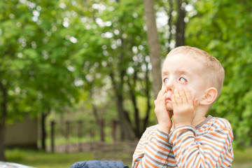 Little boy having fun pulling scary faces