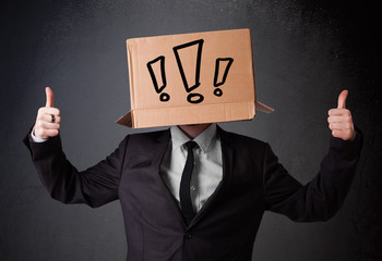 Businessman gesturing with a cardboard box on his head with excl